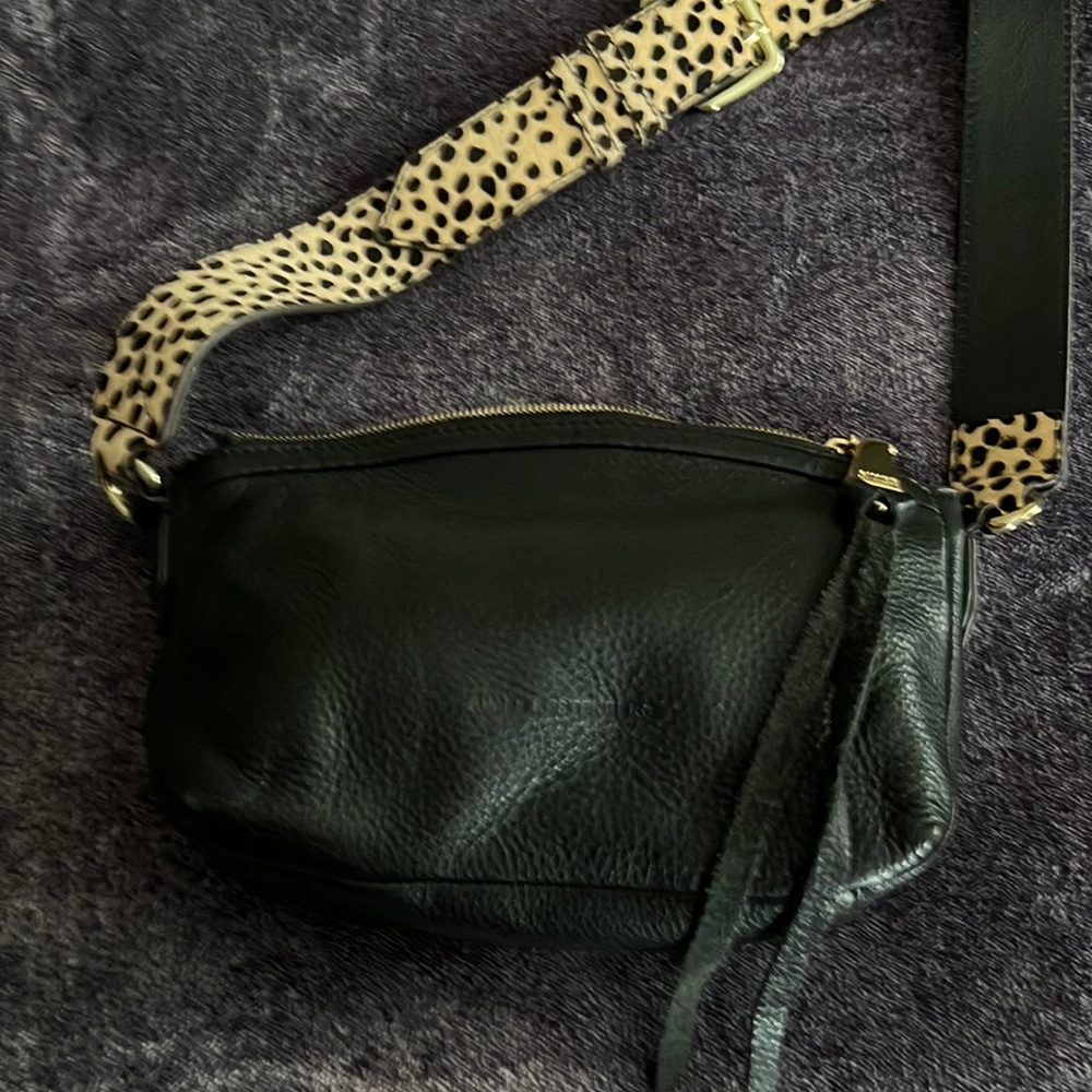 Women’s black leather handbag with adjustable cheetah strap includes dust bag